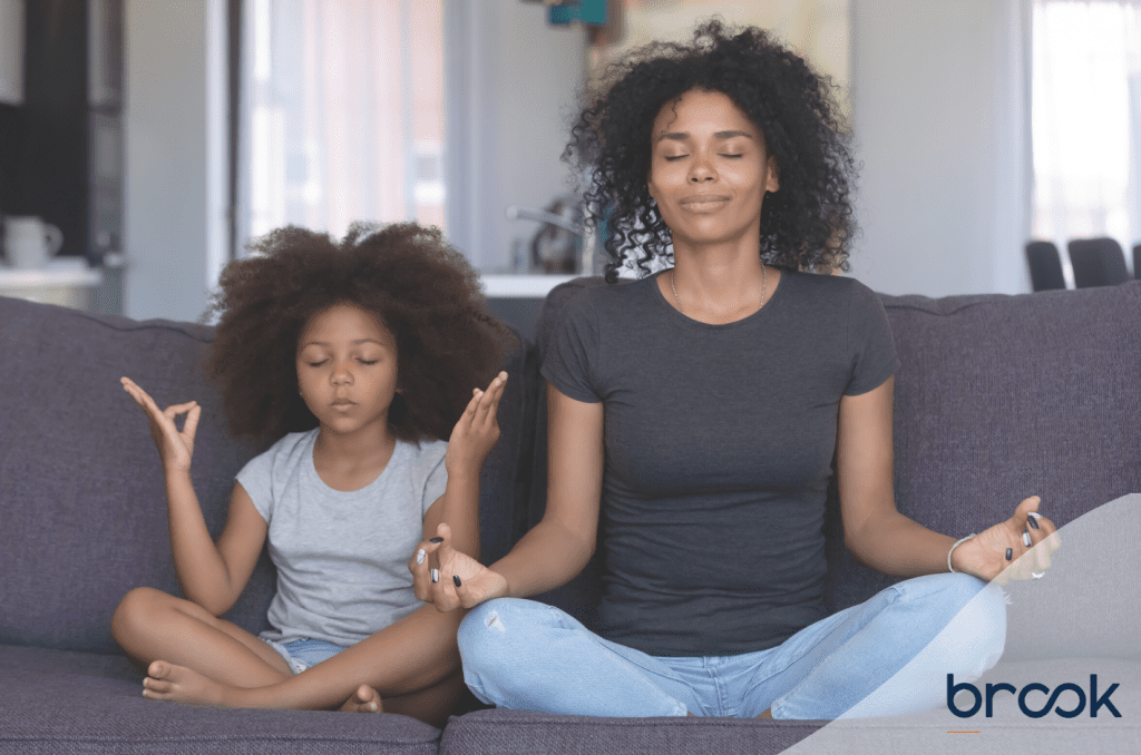 Mother and daughter meditating